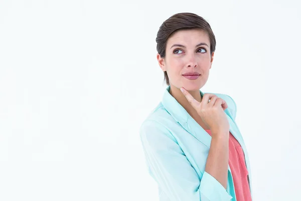 Mulher cuidadosa com o dedo na bochecha — Fotografia de Stock