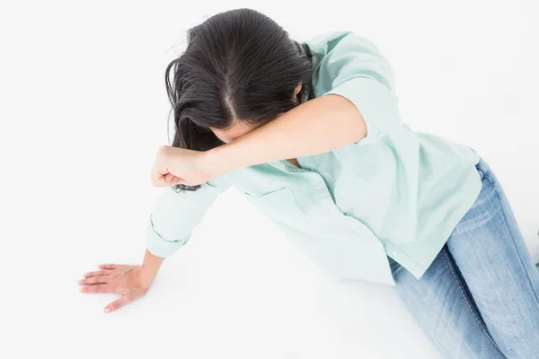 Woman on the floor hiding her face — Stock Photo, Image