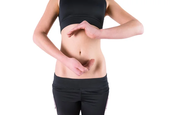 Woman with hands over belly — Stock Photo, Image