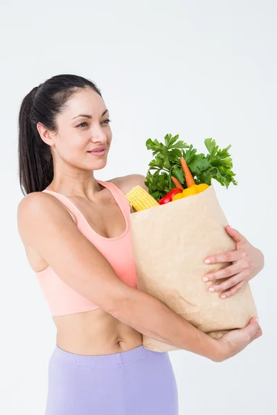 女人抓着袋子和健康的食物 — 图库照片