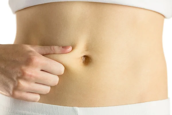 Slim woman pinching her belly — Stock Photo, Image