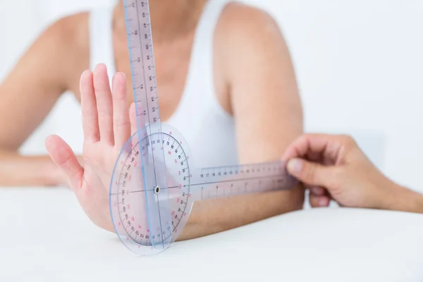 Doctor measuring wrist with goniometer — Stock Photo, Image