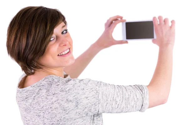 Brunette taking picture with her smartphone — Stock Photo, Image