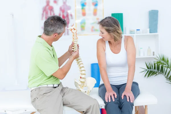 Doctor showing anatomical spine — Stock Photo, Image