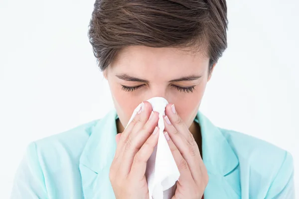 Brunette woman blowing her nose — Stock Photo, Image