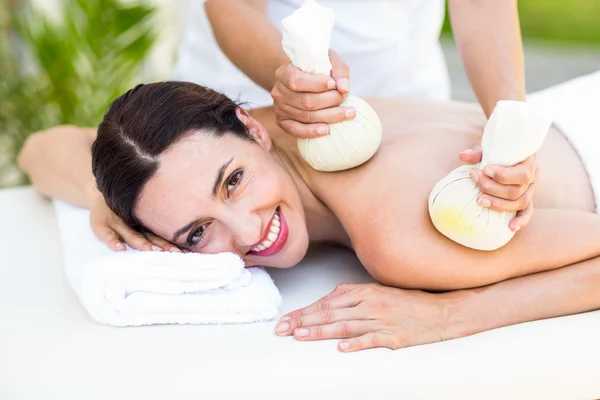 Brunette met massage met kruiden kompressen — Stockfoto