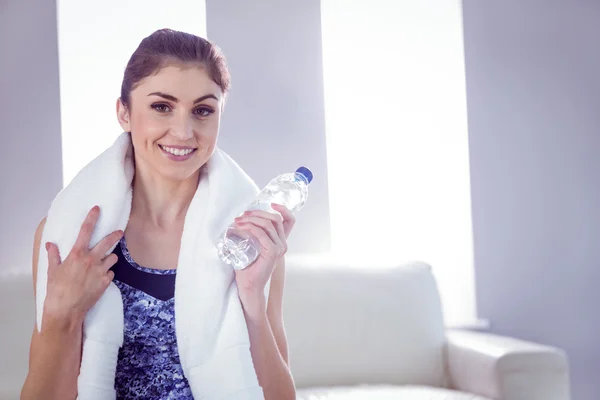 Fit woman with towel and water bottle — Stock Photo, Image