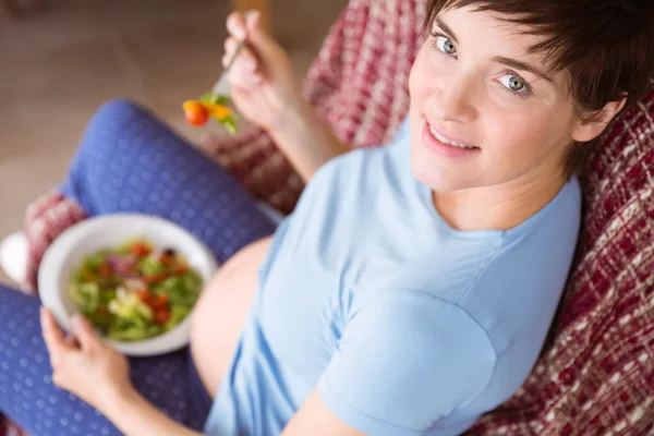 Pregnant woman eating a salad Stock Picture