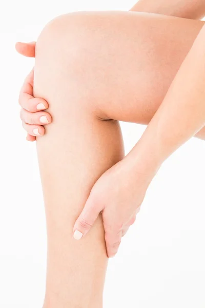 Natural woman touching her painful leg — Stock Image Natural woman touching her painful leg Royalty Free Stock Photos