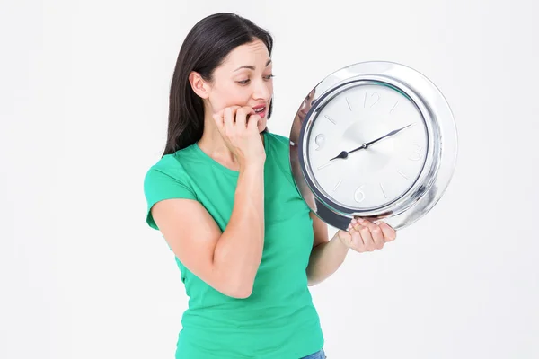 Brunette looking at wall clock — Stock Photo, Image