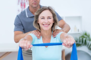 Doctor examining his patient back  clipart