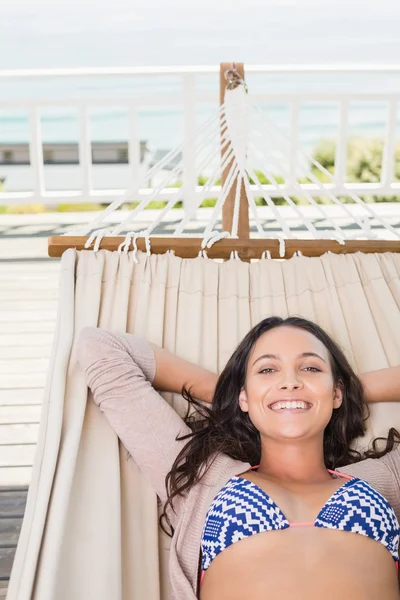 Pretty brunette relaxing on a hammock — Stock Photo, Image