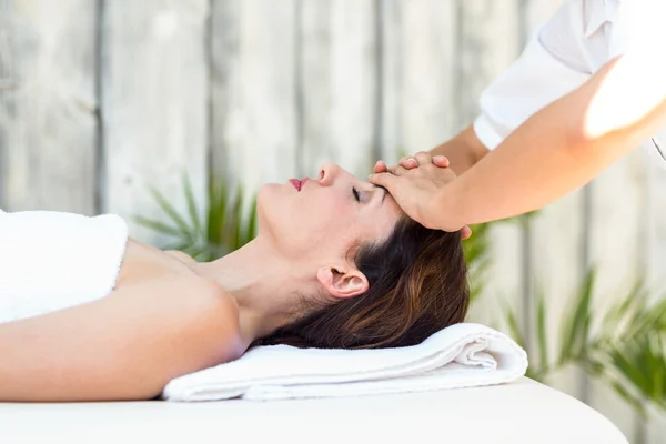 Brunette receiving forehead massage — Stock Photo, Image