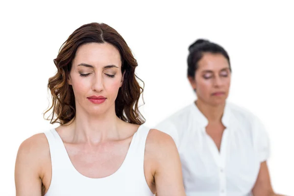 Women sitting in lotus pose — Stock Photo, Image