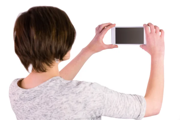 Brunette taking a picture with her smartphone — Stock Photo, Image