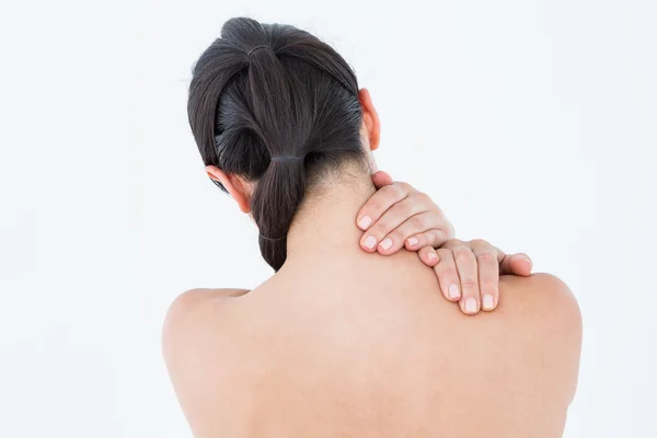 Brunette touching her painful neck — Stock Photo, Image