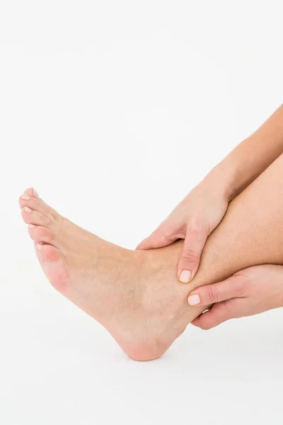 Woman touching her painful ankle — Stock Photo, Image