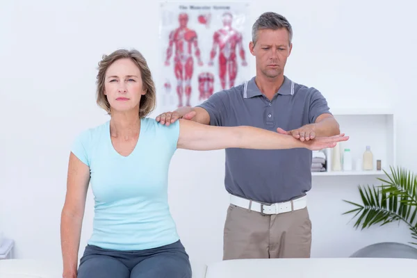 Doctor examinando su brazo paciente — Foto de Stock