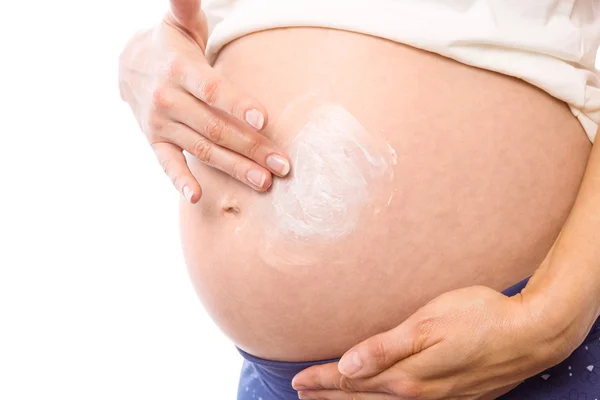 Mulher grávida com creme na colisão — Fotografia de Stock