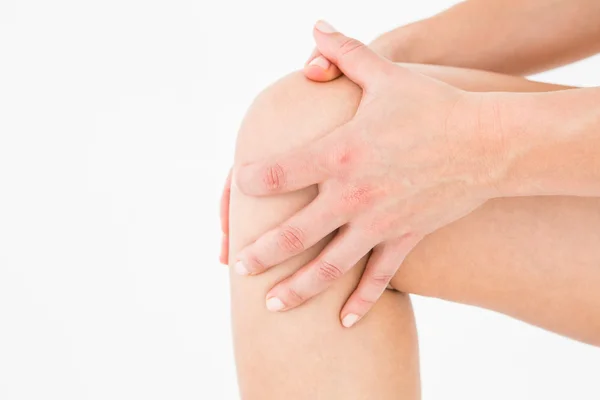 Natural woman touching her painful knee — Stock Photo, Image