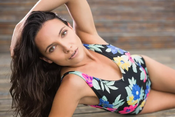 Pretty brunette lying in swimwear — Stock Photo, Image