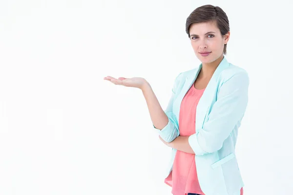 Pretty brunette woman presenting something — Stock Photo, Image