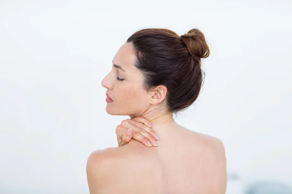 Woman touching her shoulder — Stock Photo, Image