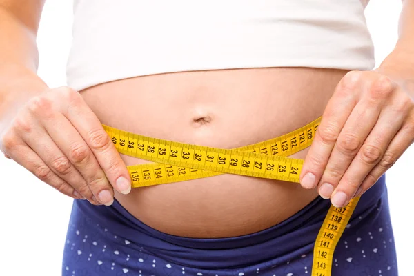 Pregnant woman measuring her bump — Stock Photo, Image