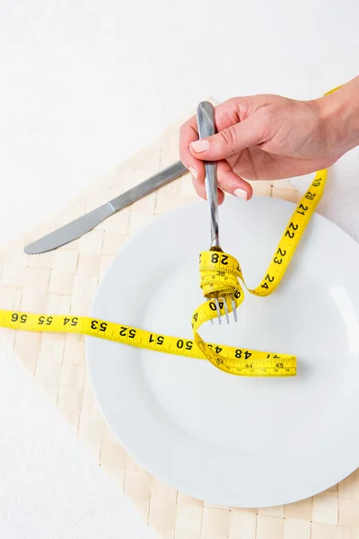 Measuring tape around the fork — Stock Photo, Image