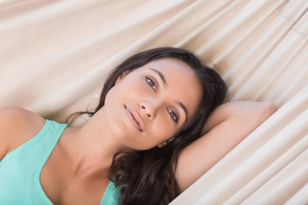 Pretty brunette relaxing on a hammock — Stock Photo, Image