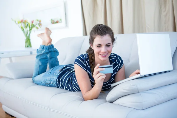 Vrouw liggen doen online winkelen — Stockfoto