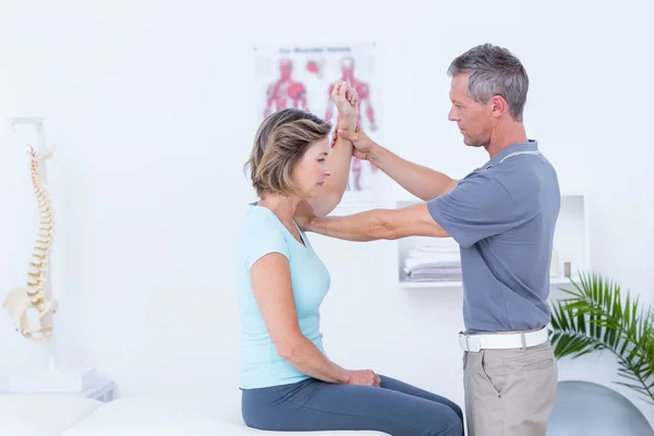 Doctor examining his patient arm — Stock Photo, Image