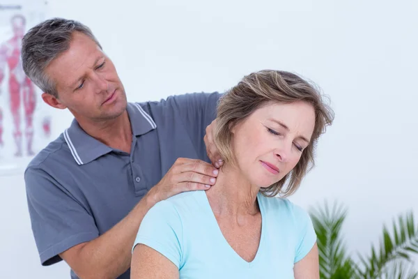 Doctor massaging his patient neck — Stock Photo, Image