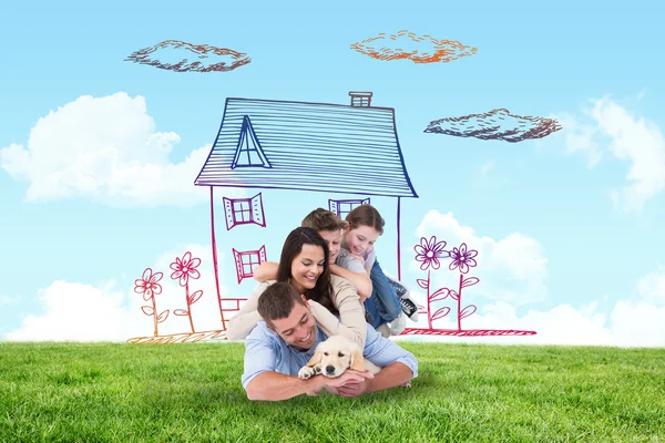 Composite image of happy family with puppy — Stock Photo, Image