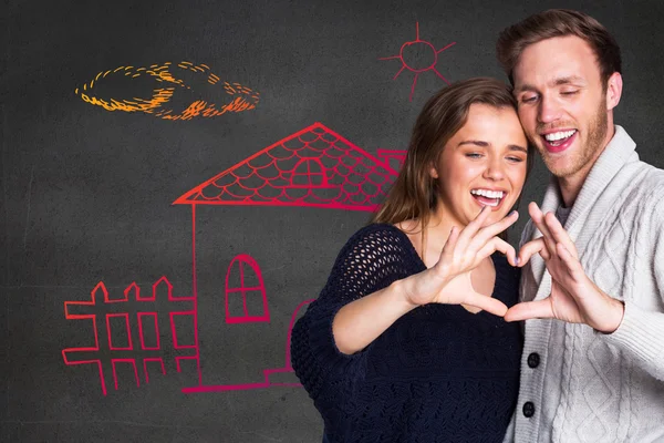 Couple forming heart with hands — Stock Photo, Image