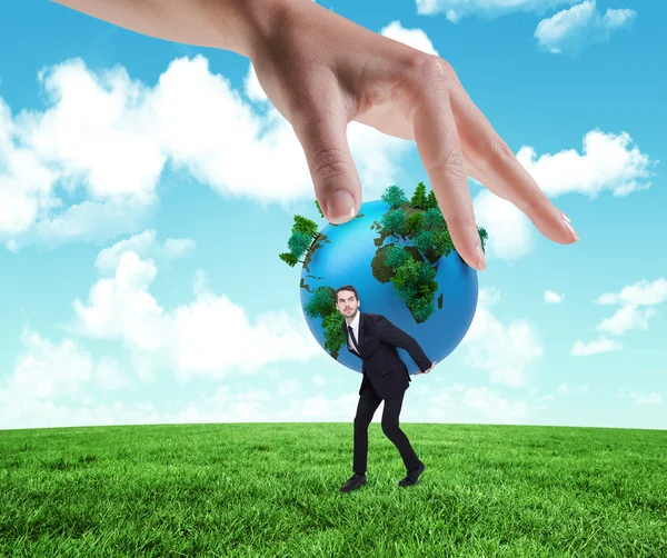 Hand holding earth and businessman — Stock Photo, Image