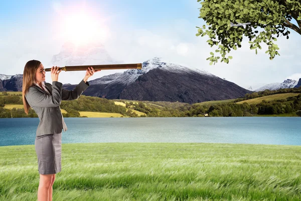 Businesswoman looking through a telescope — Stock Photo, Image