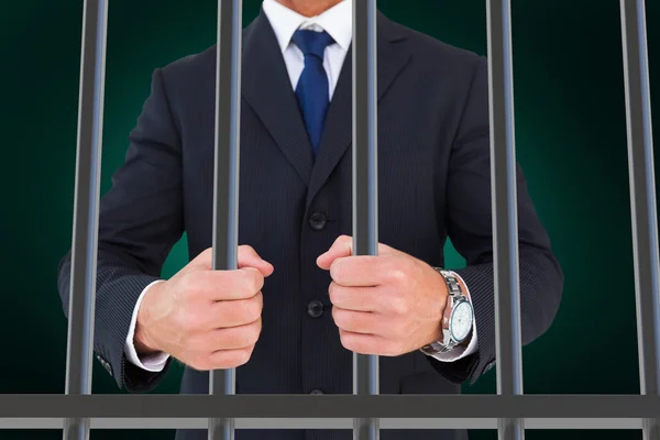 Composite image of businessman in prison — Stockfoto