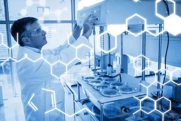 Scientist with safety glasses using the machine — Stock Photo, Image