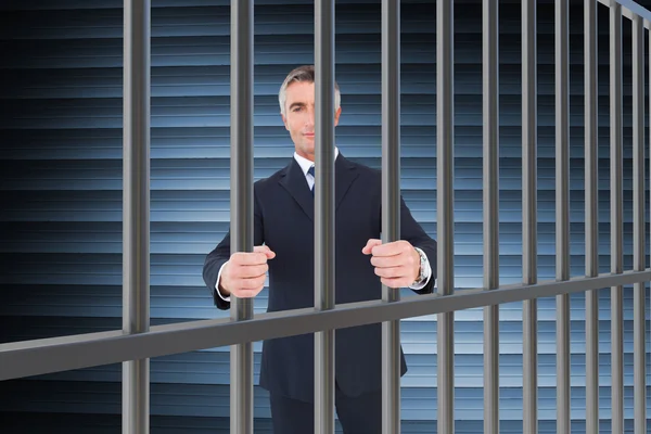 Composite image of businessman in prison — 图库照片
