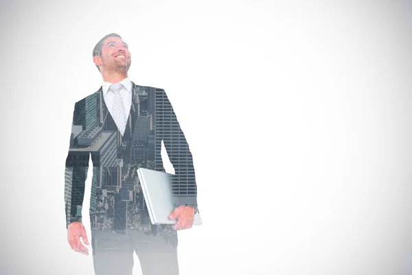 Businessman looking up holding laptop — Stock Photo, Image