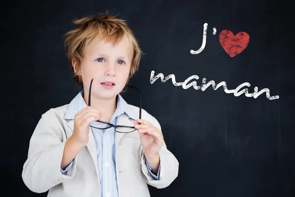 Composite image of cute pupil holding glasses — Stock Photo, Image