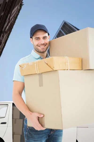 Happy delivery man carrying cardboard boxes — Stock Photo, Image