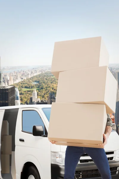 Composite image of man carrying pile of boxes — Stock Photo, Image