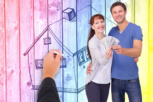 Composite image of couple holding fan of cash — Stock Photo, Image