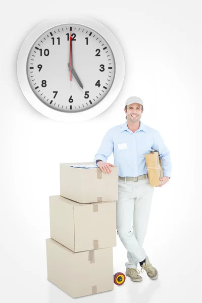 Delivery man leaning on stacked cardboard boxes — Stock Photo, Image