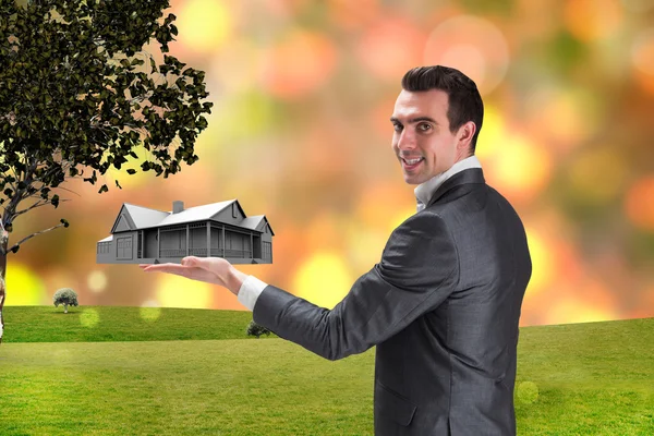 Businessman presenting with hand house — Stock Photo, Image