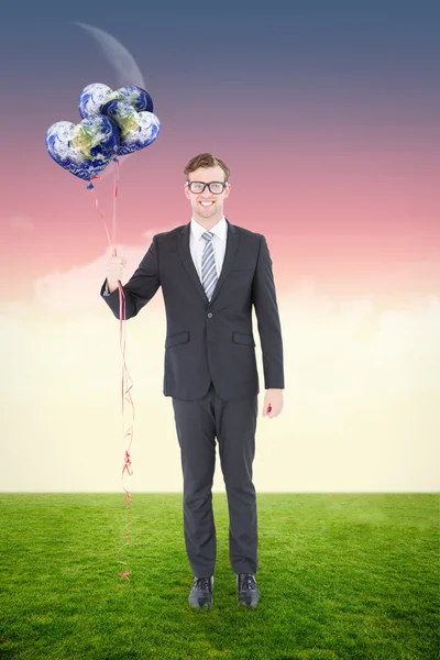 Geeky hipster businessman holding balloons — Zdjęcie stockowe