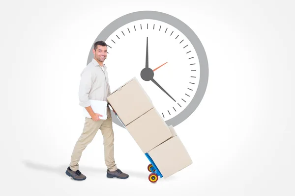 Delivery man pushing trolley of boxes — Stock Photo, Image