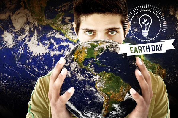 Earth day graphic against man holding earth — Stok fotoğraf